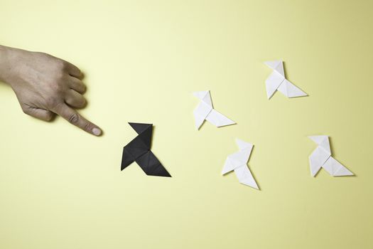 Hand pointing origami, detail of a hand pointing a paper figures, oriental art