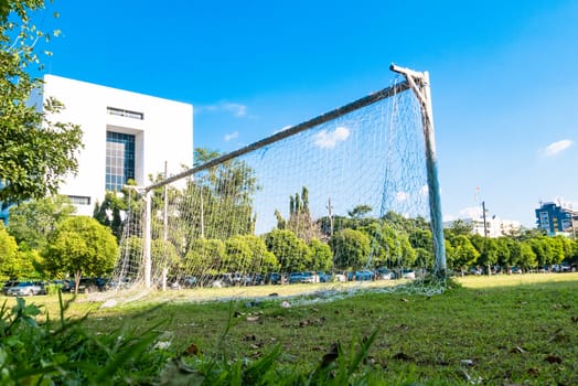 Soccer net or goal on grass field, Blue sky