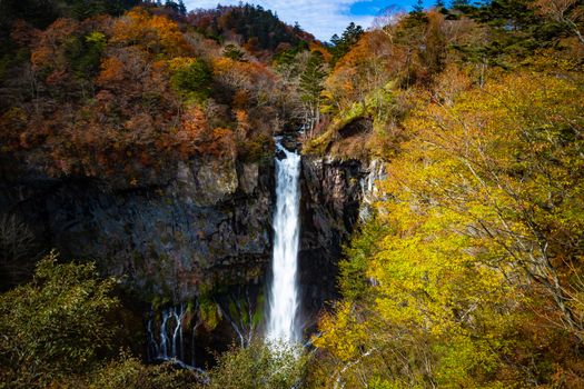 The Kegon Falls near Nikko, Japan surrounded by autumn colours