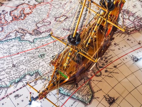 Antique Model Sailing Ship on the historic world map