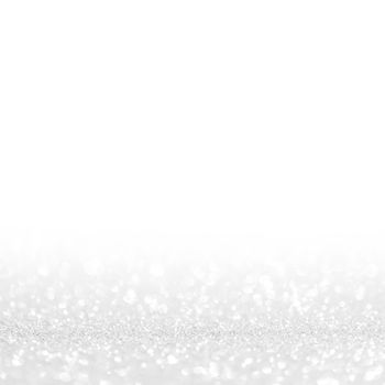 Abstract shining glitters silver holiday bokeh background with white copy space