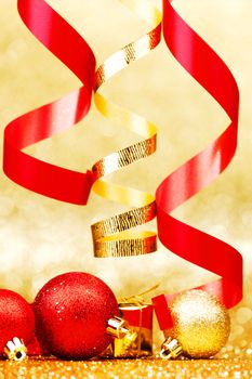 Christmas balls and ribbons on abstract glitter background