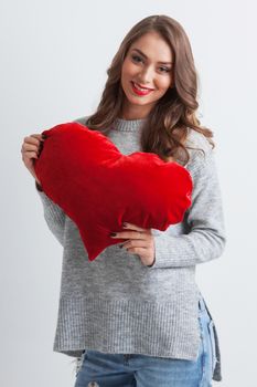 Beautiful woman with red pillow heart, valentine's day concept