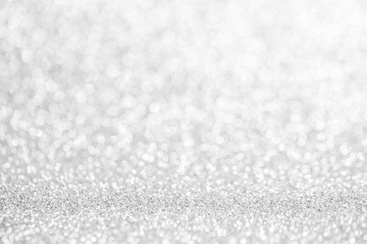 Abstract shining glitters silver holiday bokeh background with copy space for text