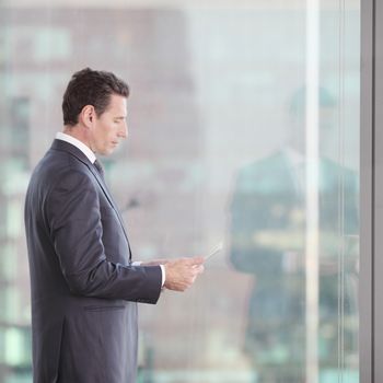 Businessman working with tablet and touching digital display