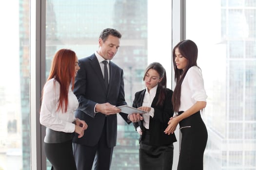Group of business people using tablet in office