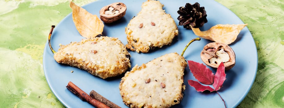 Cookies with nuts and cinnamon, in the form of a pear. Autumn baking