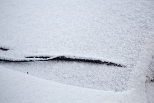 Close up of car covered in a fresh layer of snow