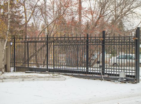 Automatic gate from a metal lattice for protection and safety of the private territory.