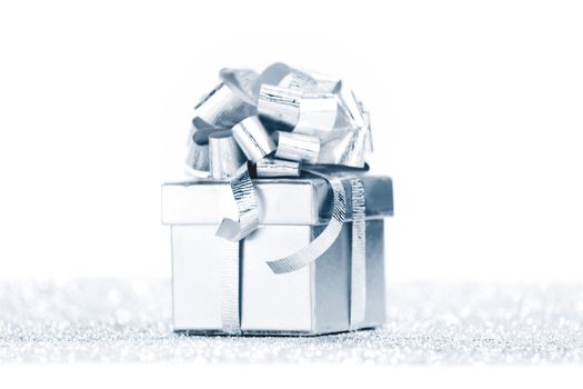 Decorated holiday gift on silver background