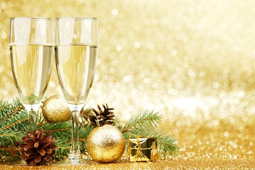 Champagne and new year decorations on golden background