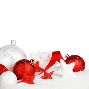 White and red christmas balls and decoration on snow