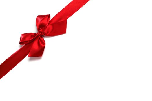 Decorative red satin bow isolated on white background
