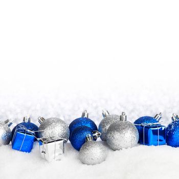 Beautiful various blue and silver christmas decor on snow close-up