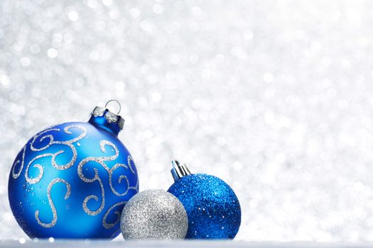 Decorative Christmas balls on abstract glitter silver background