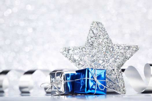 Christmas blue decoration on shiny silver glitter background