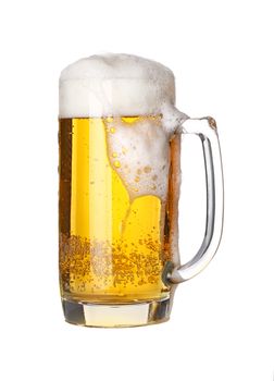 Close up one full glass mug of lager beer with froth and bubbles isolated on white background, low angle side view