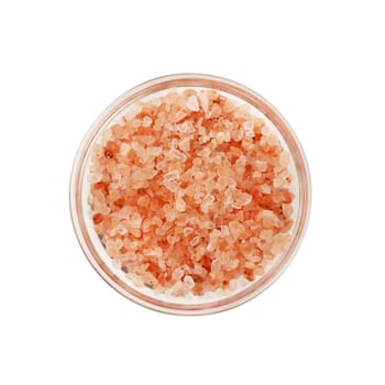 Close up one glass bowl saltcellar full of medium crystals pink Himalayan salt isolated on white background, elevated top view, directly above