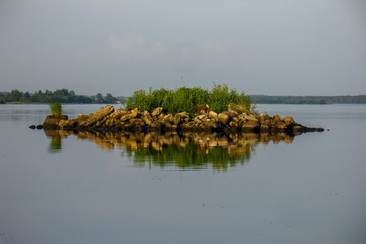 Rock with vegetation in the river.