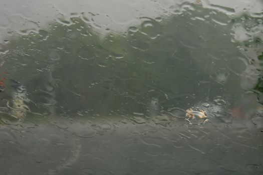 Rain drops on glass with a background.