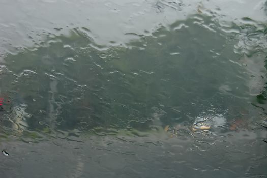 Rain drops on glass with a background.