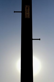 Silhouette of an electricity pole on the street of Yokohama, Japan. Yokohama is a city located in a little bit of South from Tokyo.