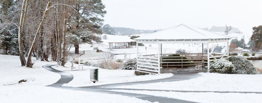 Panorama of Oberon Common during winter with a fresh snow fall cov ering the park, its trees, pergola and other facilities