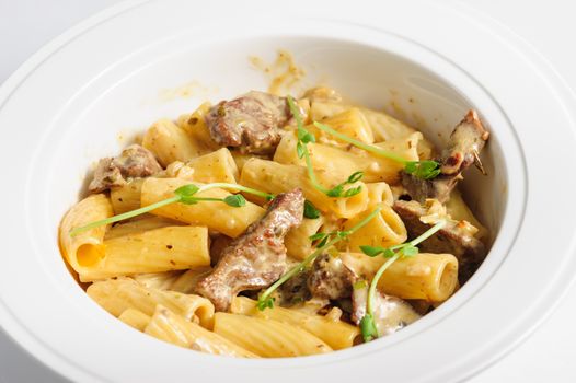 penne pasta with veal meat, macro closeup