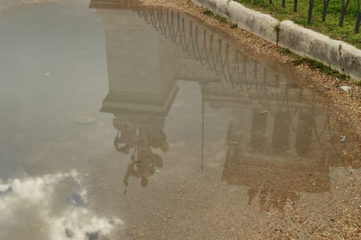 A reflection in a puddle after the rain Statue in the Vittoriano monument of Vittorio Emanuele II in Rome, Italy on October 07, 2018.