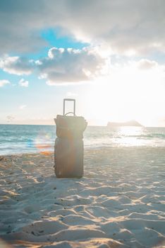 Suit Case and Hawaii pacific ocean taken in Oahu island, America. Oahu is known a tropical island located in Hawaii, United States.