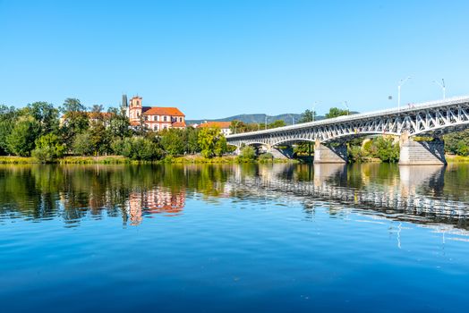 Panoramic cityscape of Litomerice reflected in Labe River, Czech Republic.