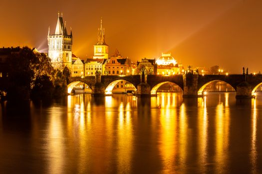 Vltava River and Charles Bridge with Old Town Bridge Tower by night, Prague, Czechia. UNESCO World Heritage Site.