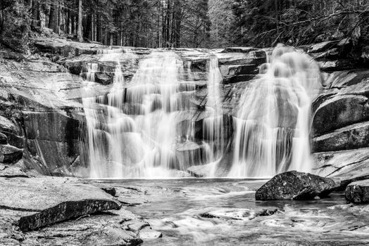 Mumlava waterfall in autumn, Harrachov, Giant Mountains, Krkonose National Park, Czech Republic. Black and white image.