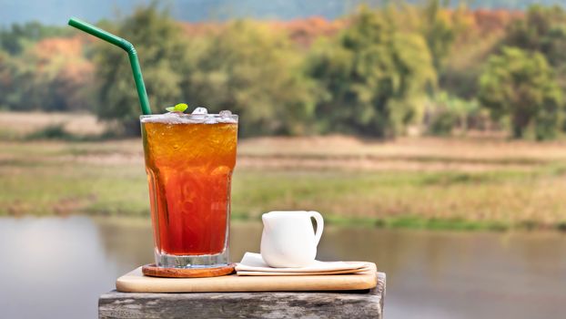 Glass of iced tea on nature background