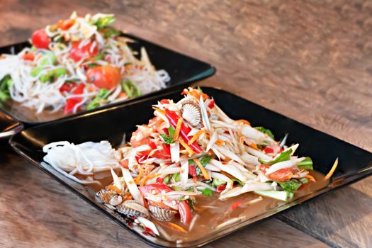 Papaya salad with blood clam , Sour and spicy . Thai style food