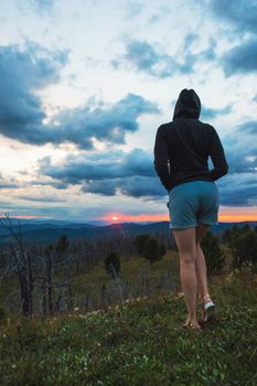 Travel, lesure and freedom concept - woman on the top of Altai mountain, beauty summer evening landcape