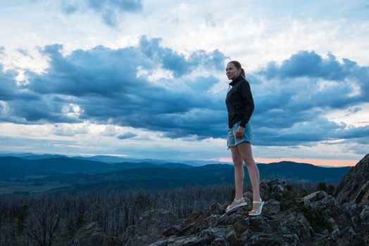 Travel, lesure and freedom concept - woman on the top of Altai mountain, beauty summer evening landcape