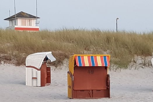 A group of beach chairs - beach chairs on beautiful beach with sand dunes in the background at blue sky - luxury vacation