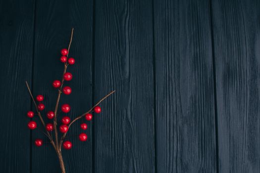 Christmas composition. Fir branches needles and berries of viburnum on a black background. New Year's composition