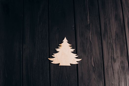 New Year composition with pine tree from plywood. Christmas background for presentation on wooden background holiday