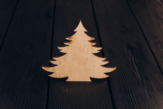 New Year composition with pine tree from plywood. Christmas background for presentation on wooden background holiday