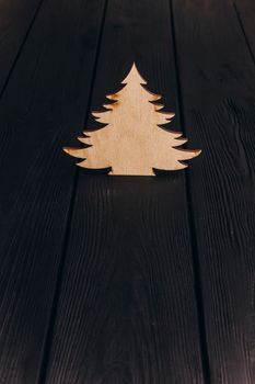 New Year composition with pine tree from plywood. Christmas background for presentation on wooden background holiday