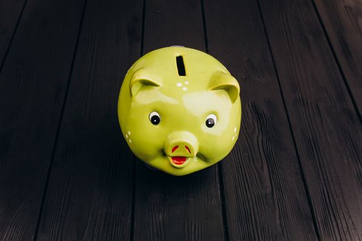 Cute Piggy Bank on the Wooden Table