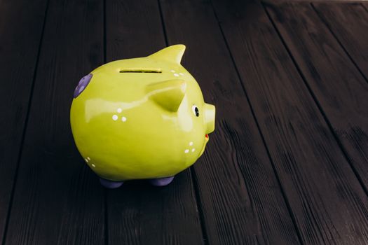 Cute Piggy Bank on the Wooden Table