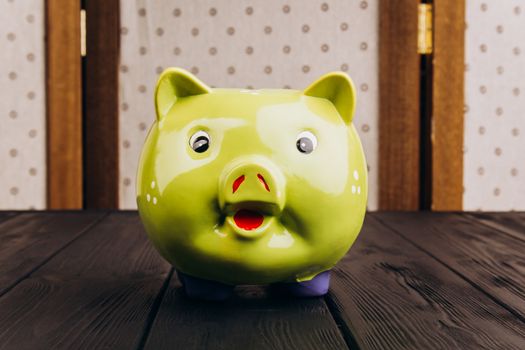 Cute Piggy Bank on the Wooden Table