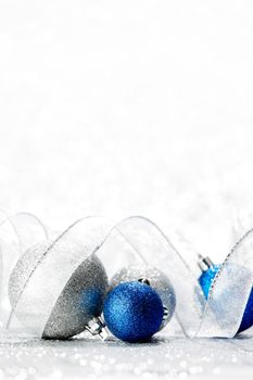 Silver and blue decorative christmas balls on bokeh background