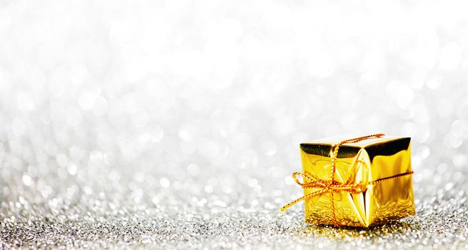 Decorative holiday gift box on bright shiny background