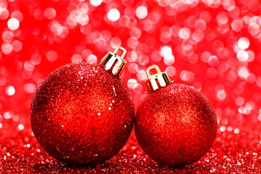 Beautiful red christmas balls on abstract glitter background close-up