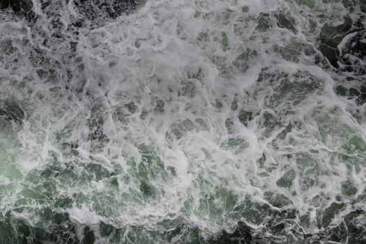 Big water splash seen from above a boat