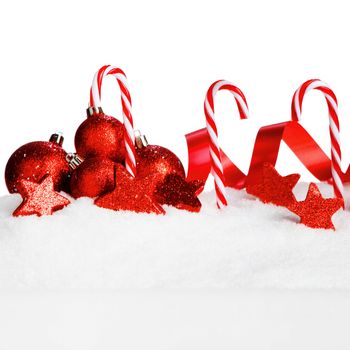 Christmas card with beautiful decorations and candies in snow